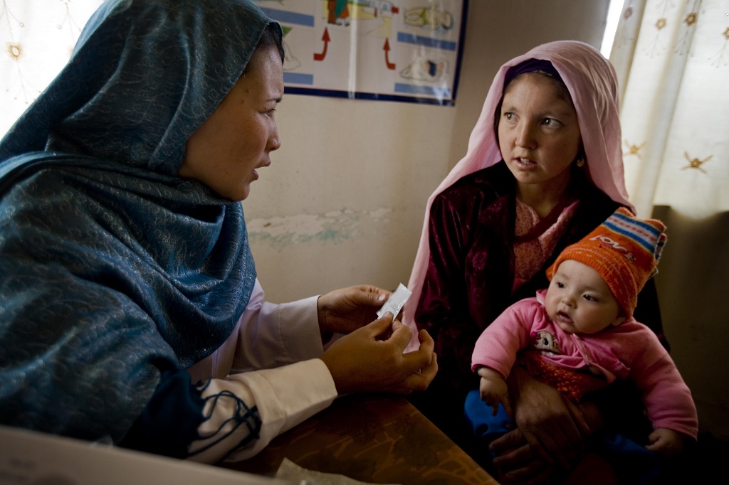 A community midiwife talks to a young mother of three about family planning at a community health center in Bamyan, Afghanistan.