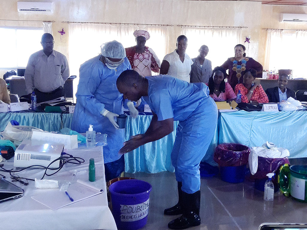 Participants in an infection prevention and control training in Guinea learn key skills.
