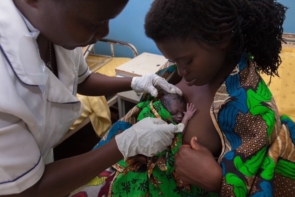 Mother with newborn receiving Kangaroo Mother Care in Malawi