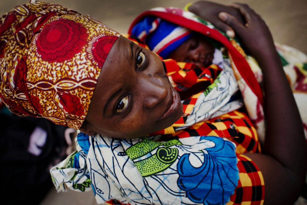 Woman and newborn waiting for a doctor outside a hospital in Nampula, Mozambique.