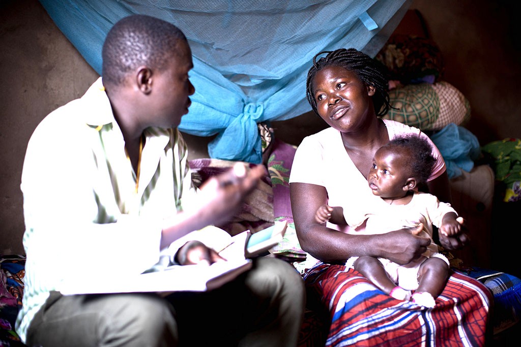 A community health worker visits a mother at home in Mozambique