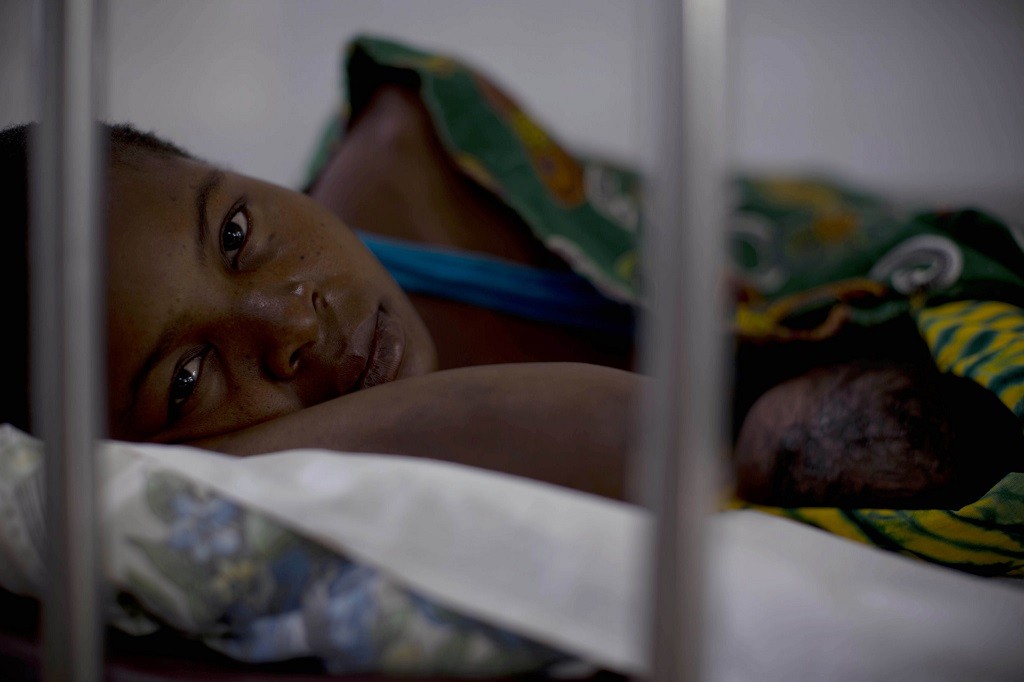 Woman lying in bed in prenatal ward at Marere Hosital in Nampula, Mozambique