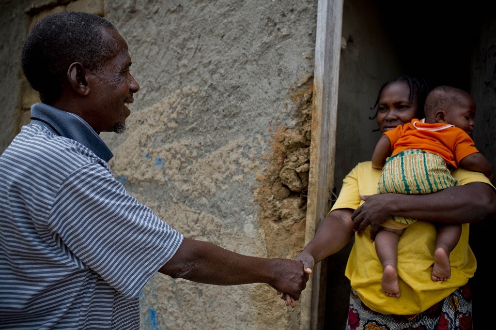 Virginia Maria, a mother of eight, is visited by Aiuba, a community health worker, in Nampula, Mozambique.