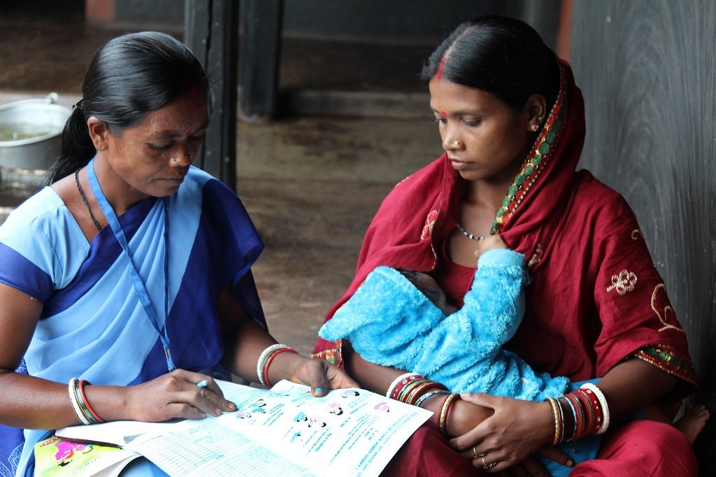 An accredited Social Health Activist in northeastern India discusses the importance of exclusive breastfeeding in the first six months with a new mother.