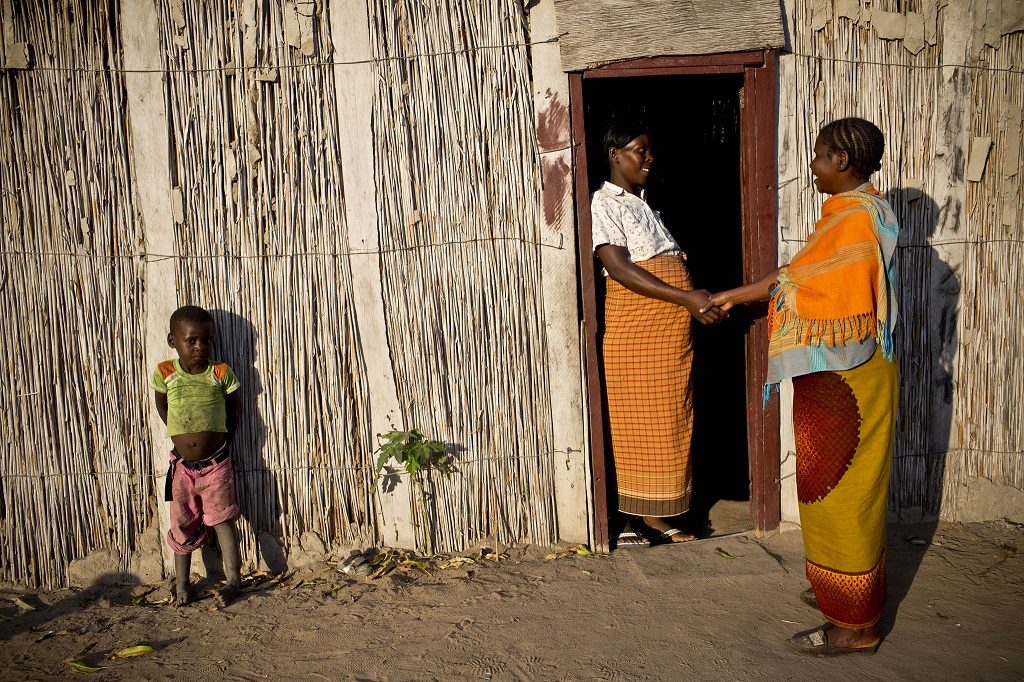 A mother of six children in Mozambique discusses nutrition and family planning with a community health worker at her home.