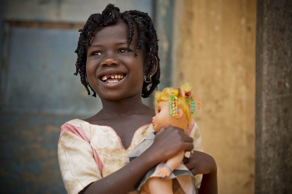 Girl in Ghana holding a doll