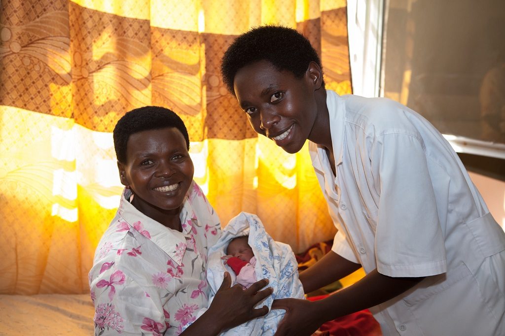 In the postpartum room of Nzige Health Center in Rwanda, a mother and newborn are attended by an MCSP-trained midwife.
