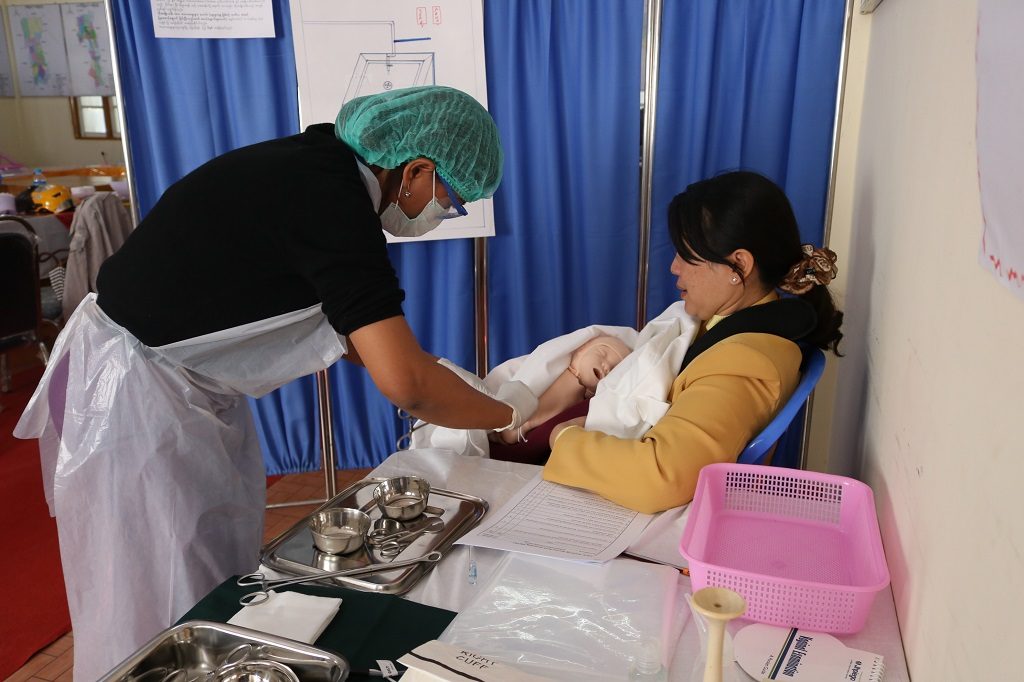 A State Health Training Team Member practices newborn care with a simulation model at Taunggyi L&PIC, Southern Shan State.