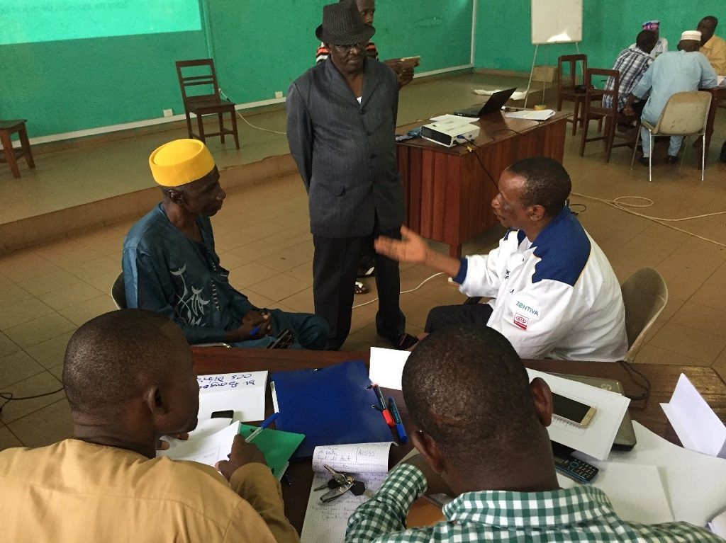 Members of the Boké district health management team role play to practice using effective communication techniques during the regional training on resource mobilization and stakeholder coordination.