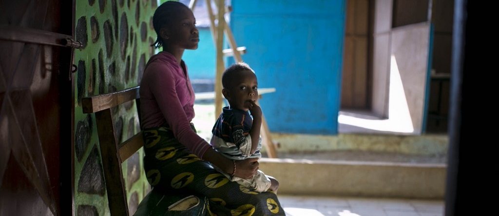 A mother and her child waiting to see a doctor in Liberia.
