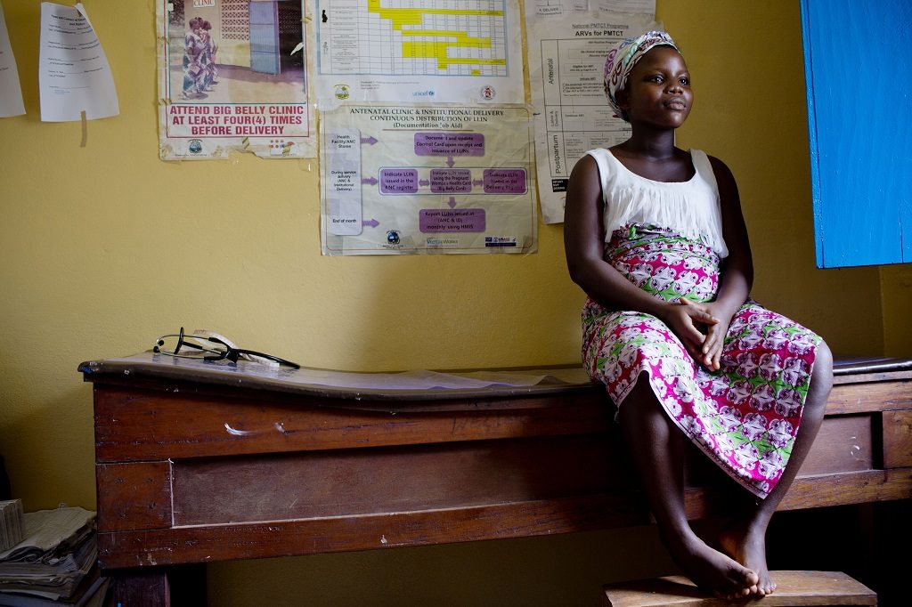 17-year-old Maria, pregnant with her second child, waits to be examined at a clinic in Liberia.