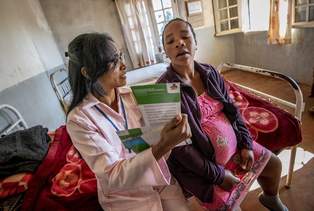 A midwife in Madagascar discusses family planning with a woman in labor with her seventh child
