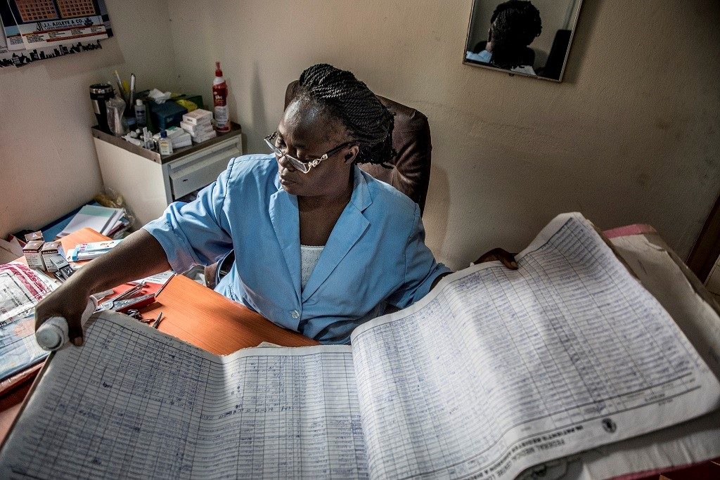 Rosemary Amaje, maternity ward manager at Nigeria’s Lokoja Federal Medical Center, checks patient data in the log book