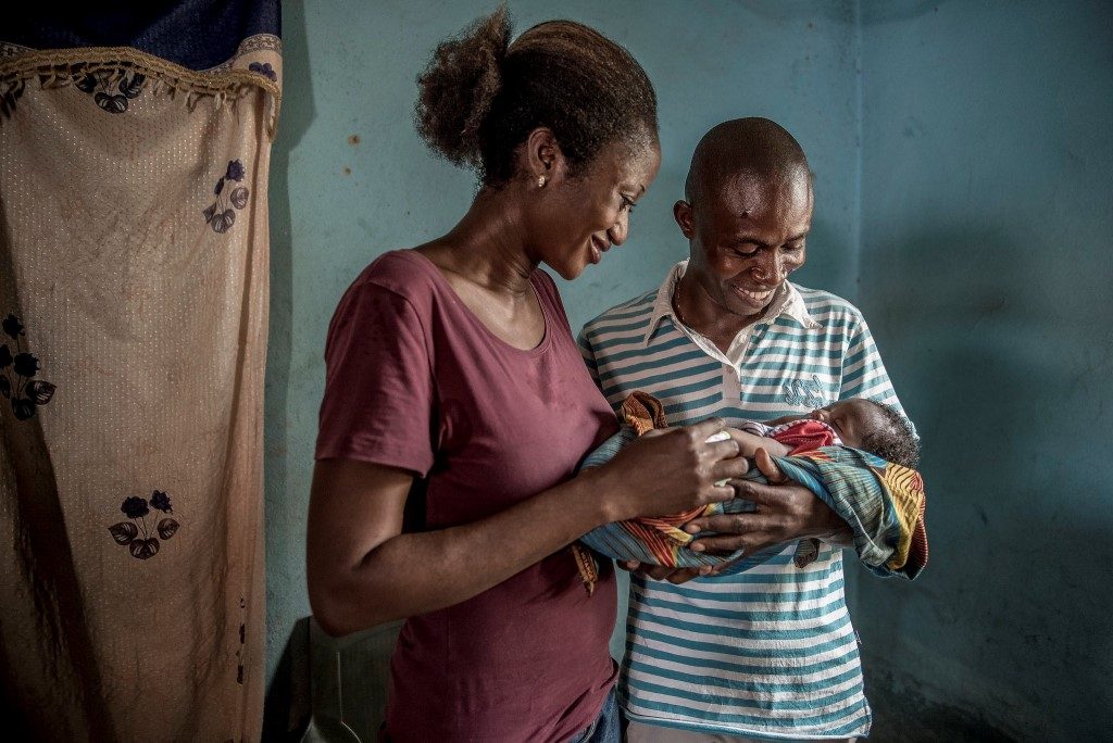 Husband and wife with baby in Nigeria.